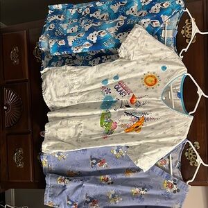 Set of three Disney scrub tops .